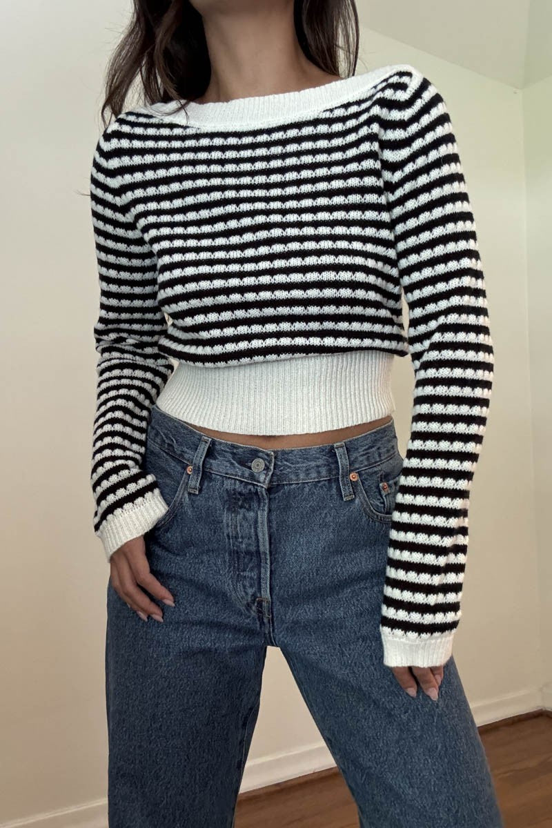 Featuring a knit black and white stripped cropped sweater