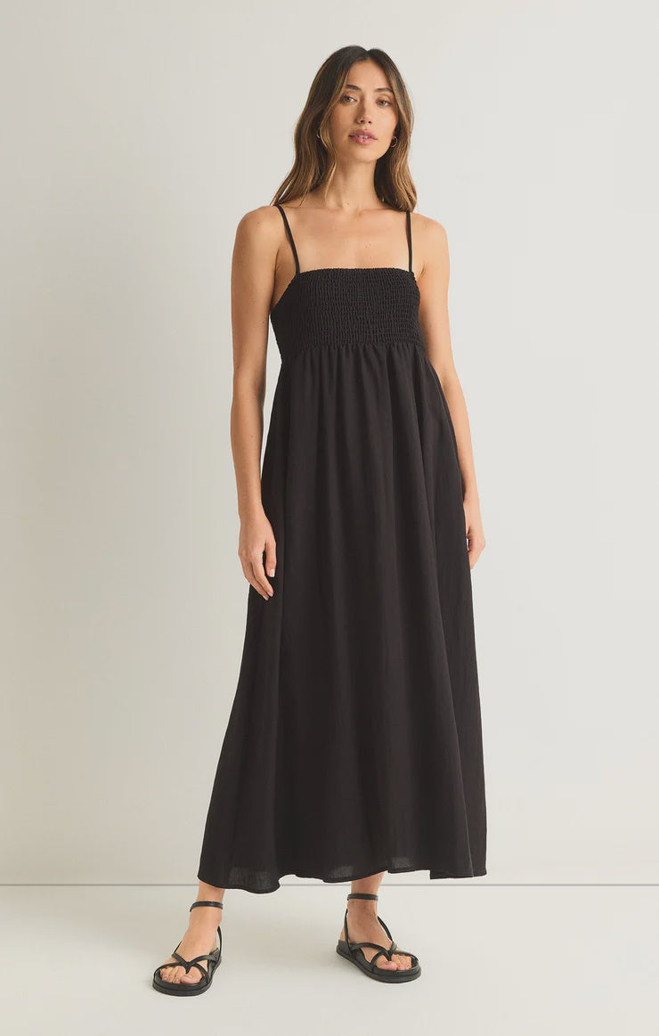 Featuring a midi dress with a smocked bodice and adjustable staps in the color black 