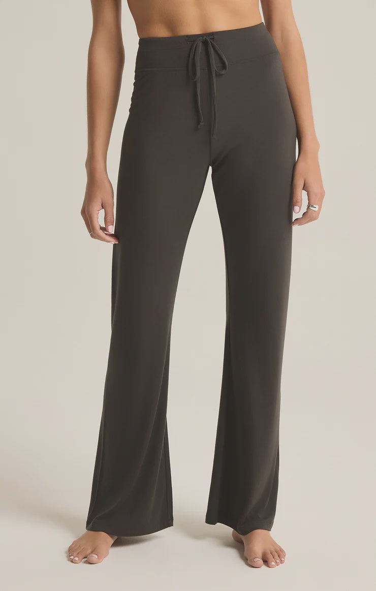 Featuring a flare drawstring pant in the color black sand 