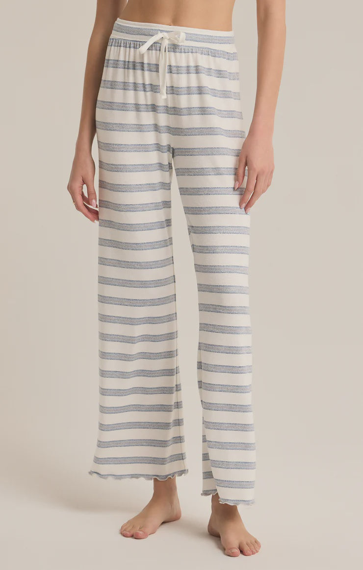 Featuring a striped lounge pant with a draw string in the color vanilla ice