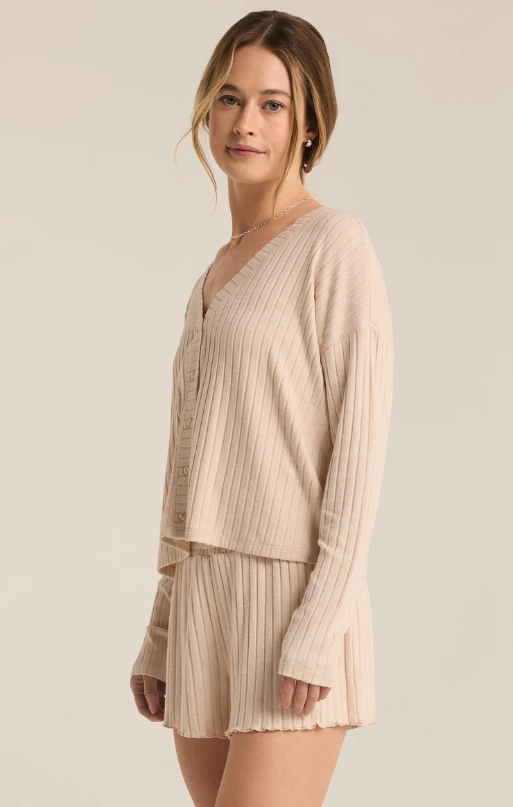 Featuring a ribbed button up long sleeve top in the color oatmeal heather 