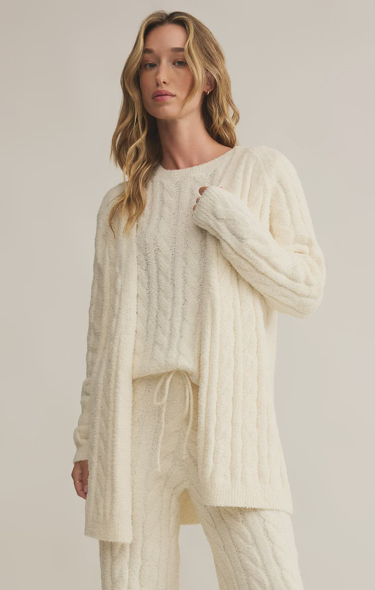 Featuring a cozy oversized long sleeve cable knit cardigan in the color sea salt