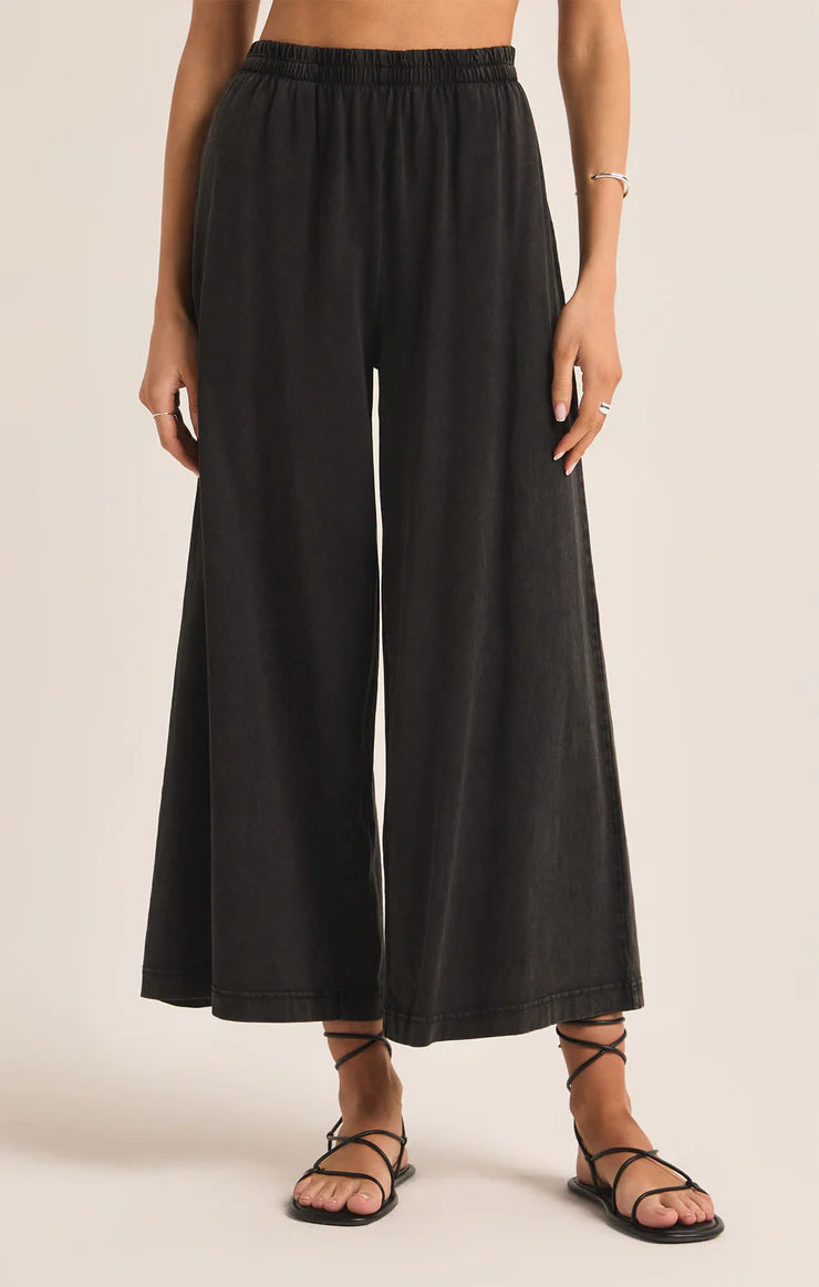 Featuring an elastic high waisted crop pant in the color black 