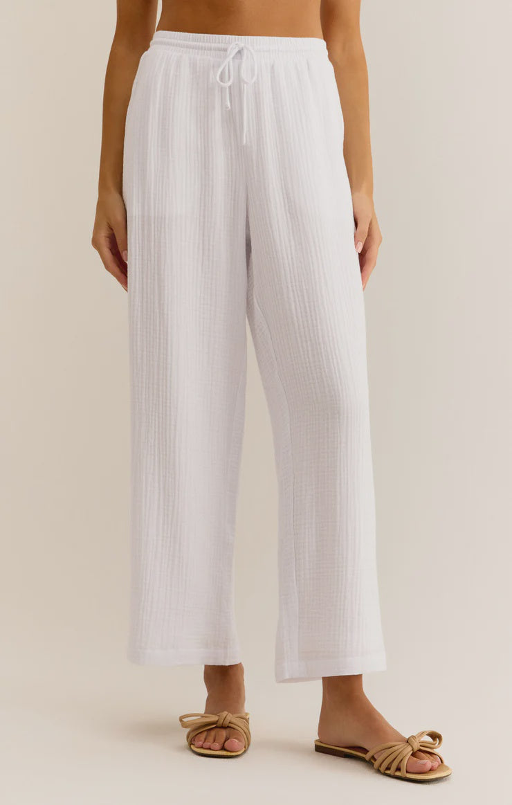 Featuring a relaxed fit linen pant with inner liner, front tie and elastic waist band in the color white 