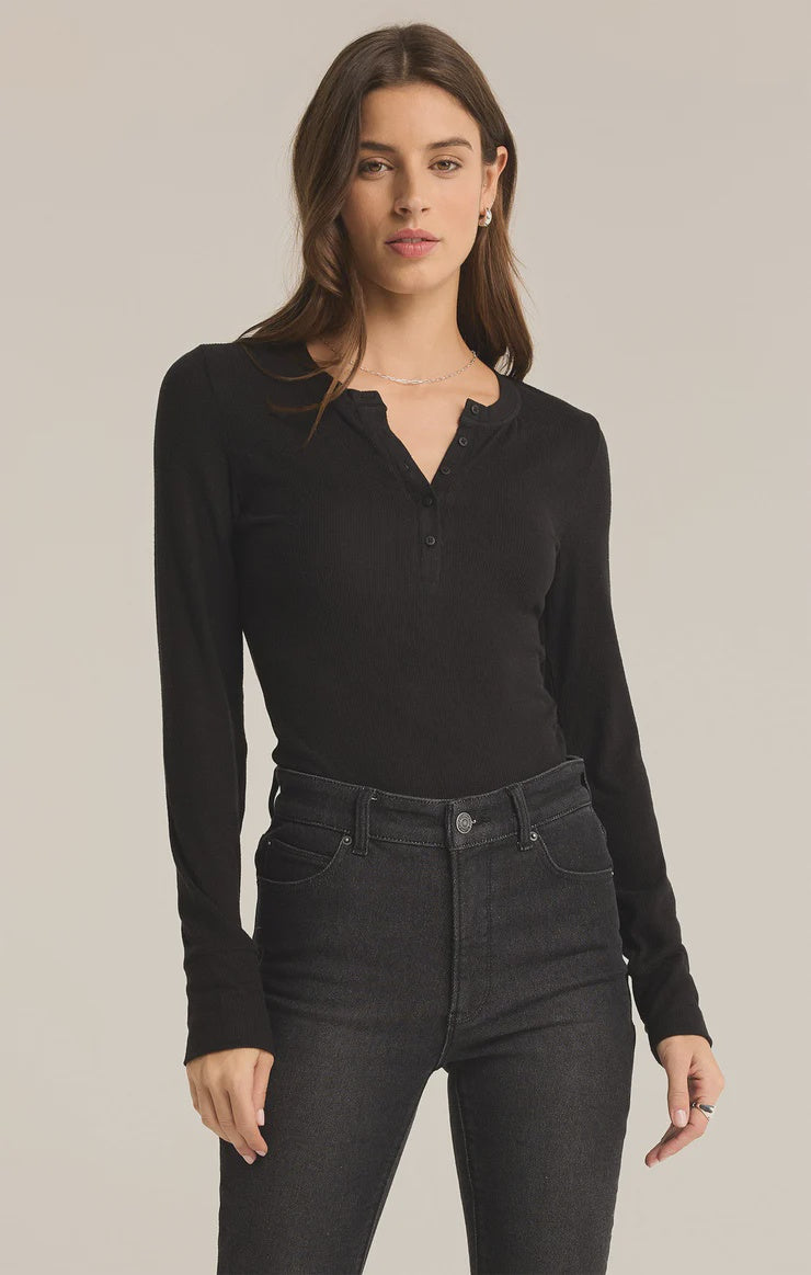 Featuring a button front long sleeve midweight top in the color black; model is wearing a size small