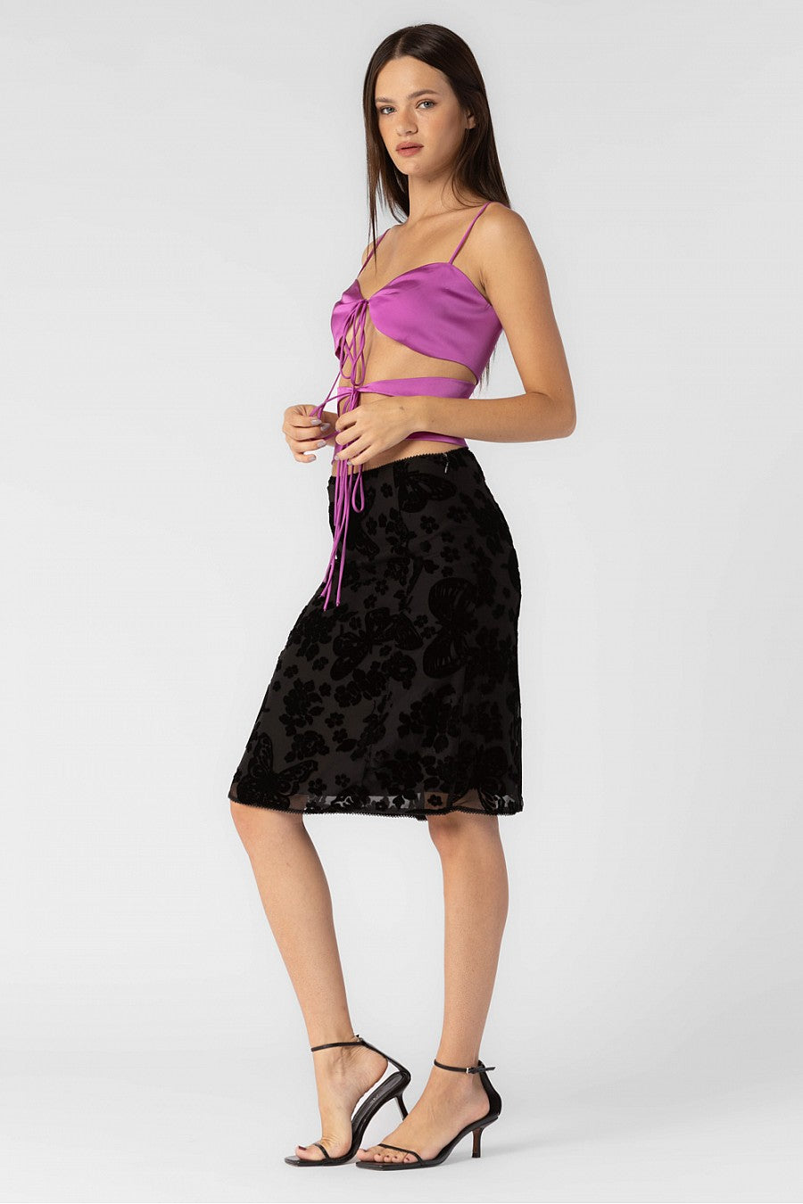 Satin spaghetti strap top with front cut-outs that tie in the front.