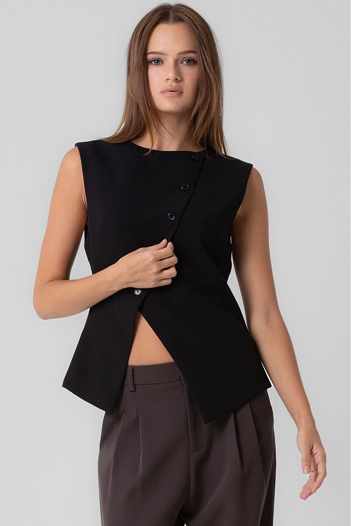 Featuring an asymmetrical button up sleeveless top in the color black 