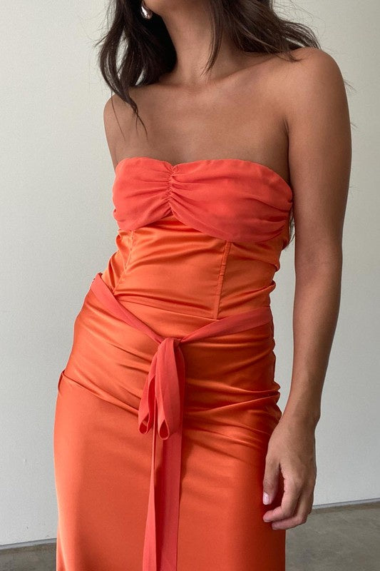 Featuring a lace up tube top in the color carrot 