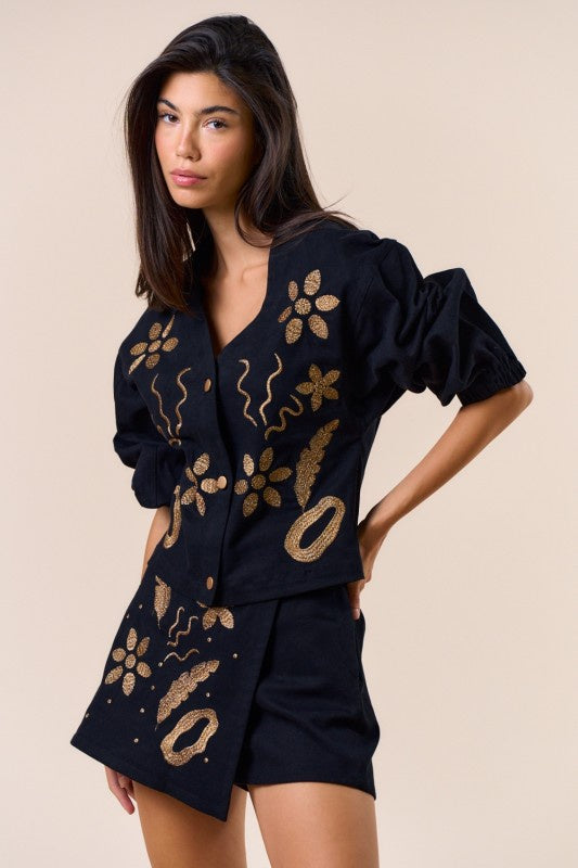 Featuring a embroidered long sleeve button down top