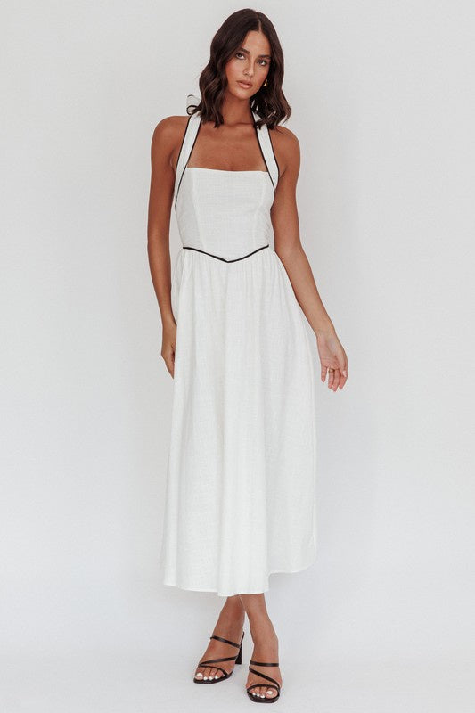 Featuring a square neck halter style maxi dress in the color white with a black trim