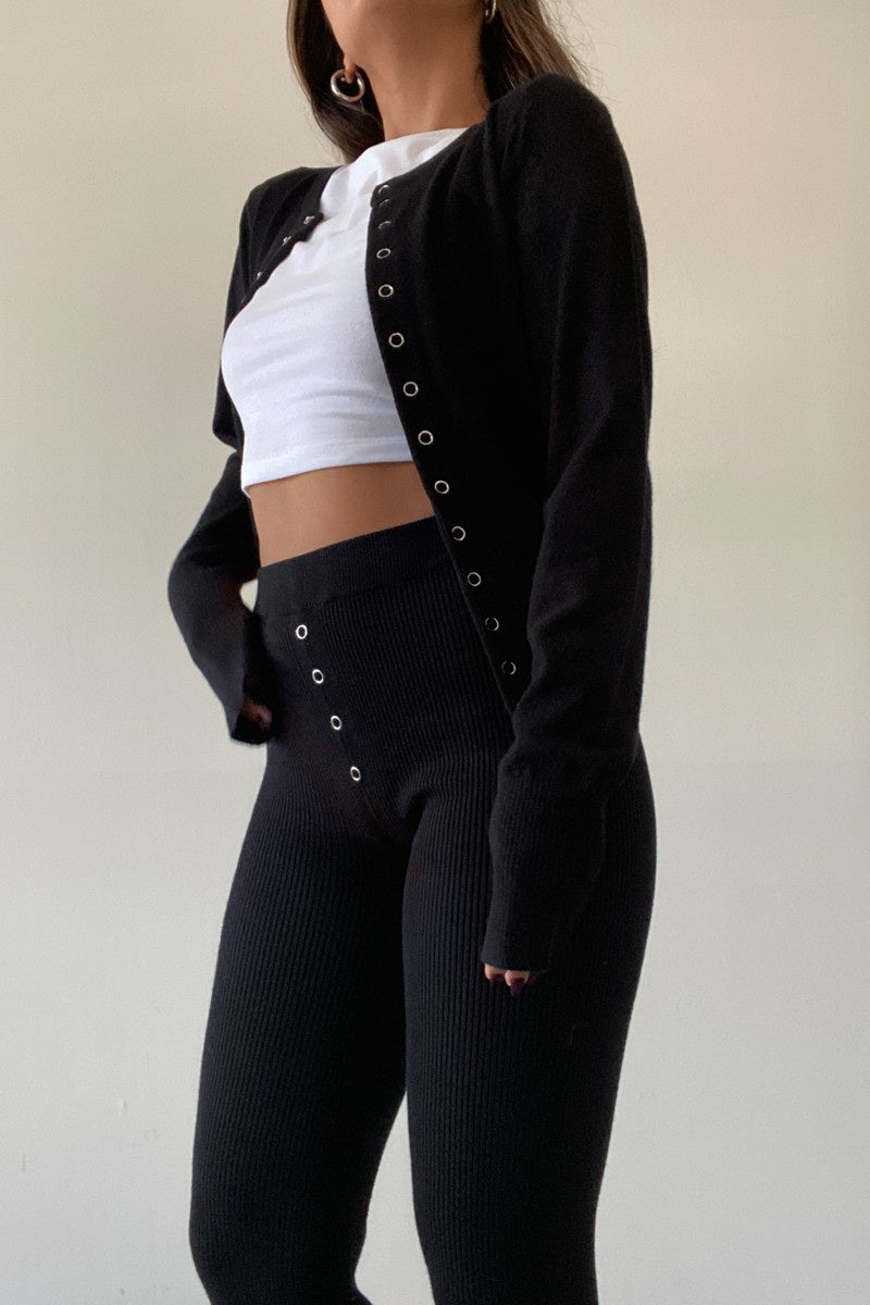 Pairs with the matching 'Kya Knit Pants'

Featuring a fitted button up cropped cardigan in the color black 