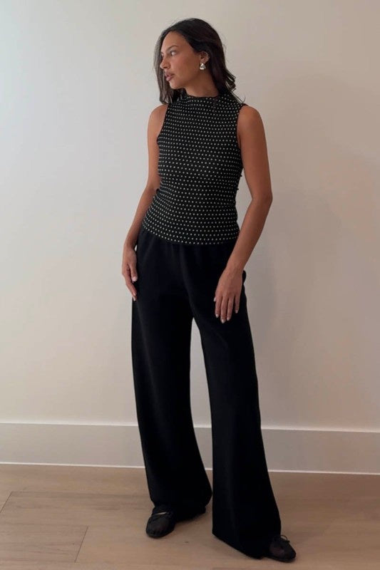 Featuring a textured high neck polka dot top