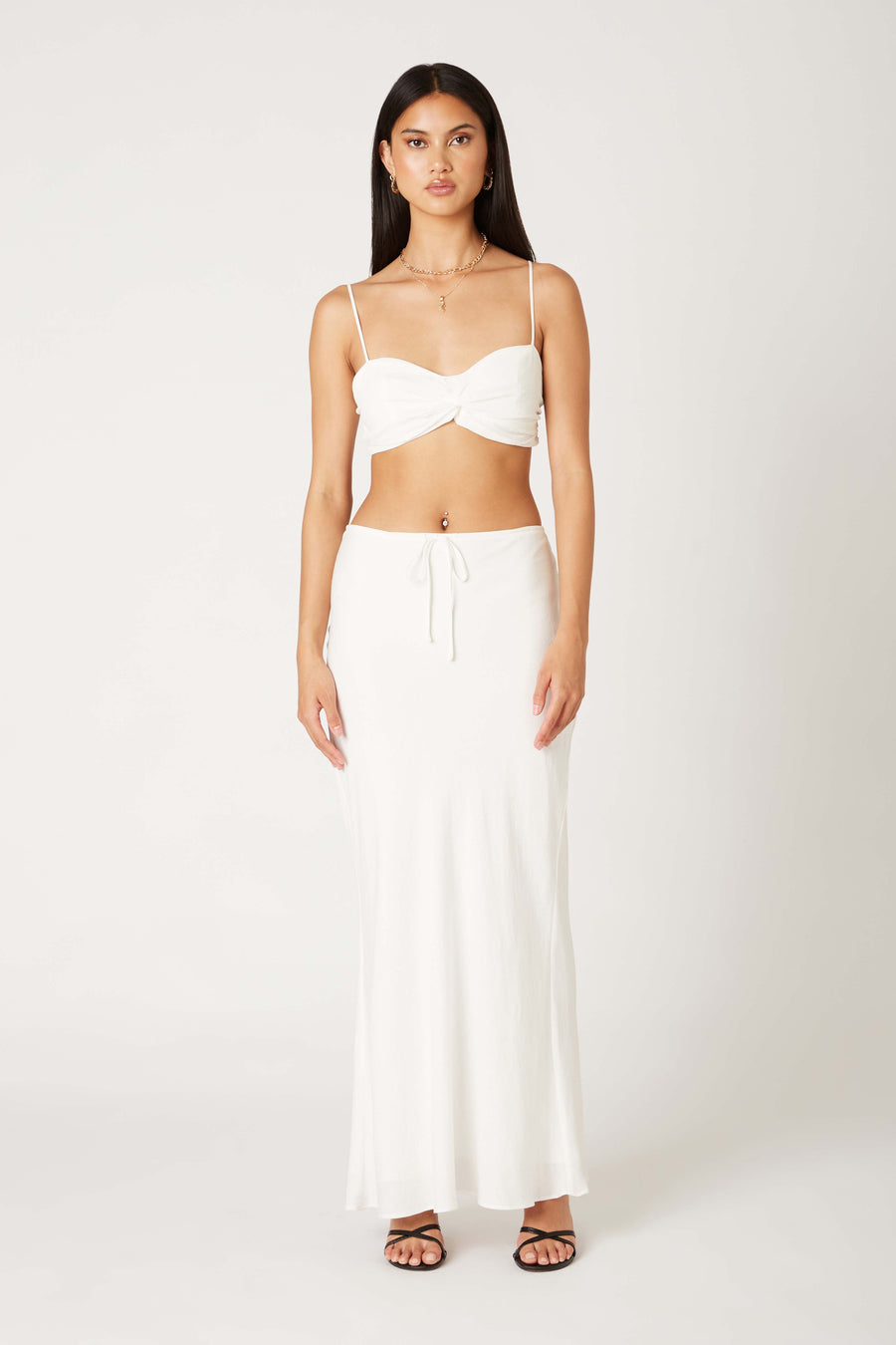 Pairs with the matching Breila Maxi Skirt

Featuring a cropped thin strap twist front tank

In the color white 