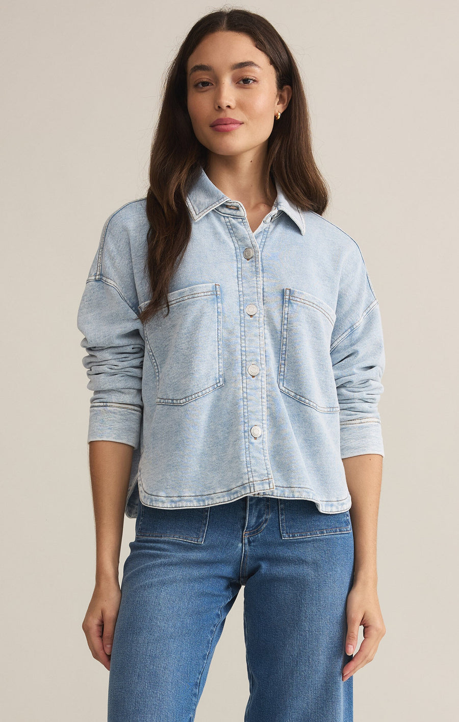 Featuring a relaxed fit long sleeve button up knit denim jacket in the color washed indigo 