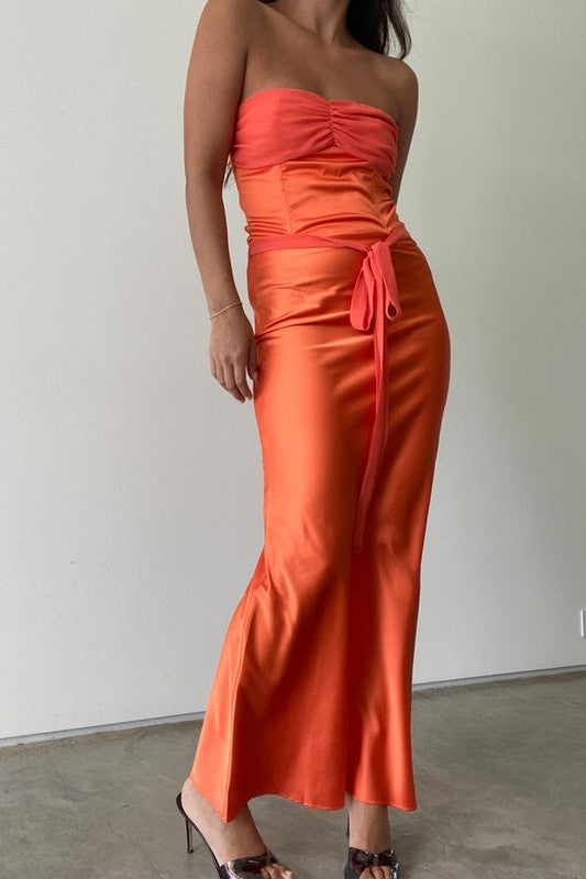 Featuring a satin waist tie maxi skirt in the color orange 