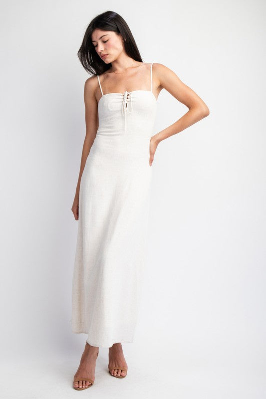 Featuring a linen maxi dress with a front lace up detail in the color oatmeal 