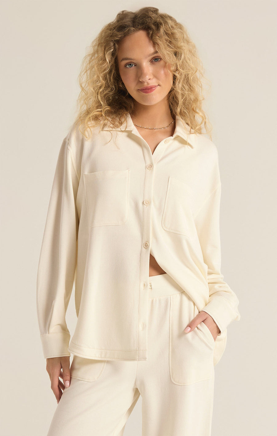 Featuring a button up long sleeve lounge top in the color sea salt 