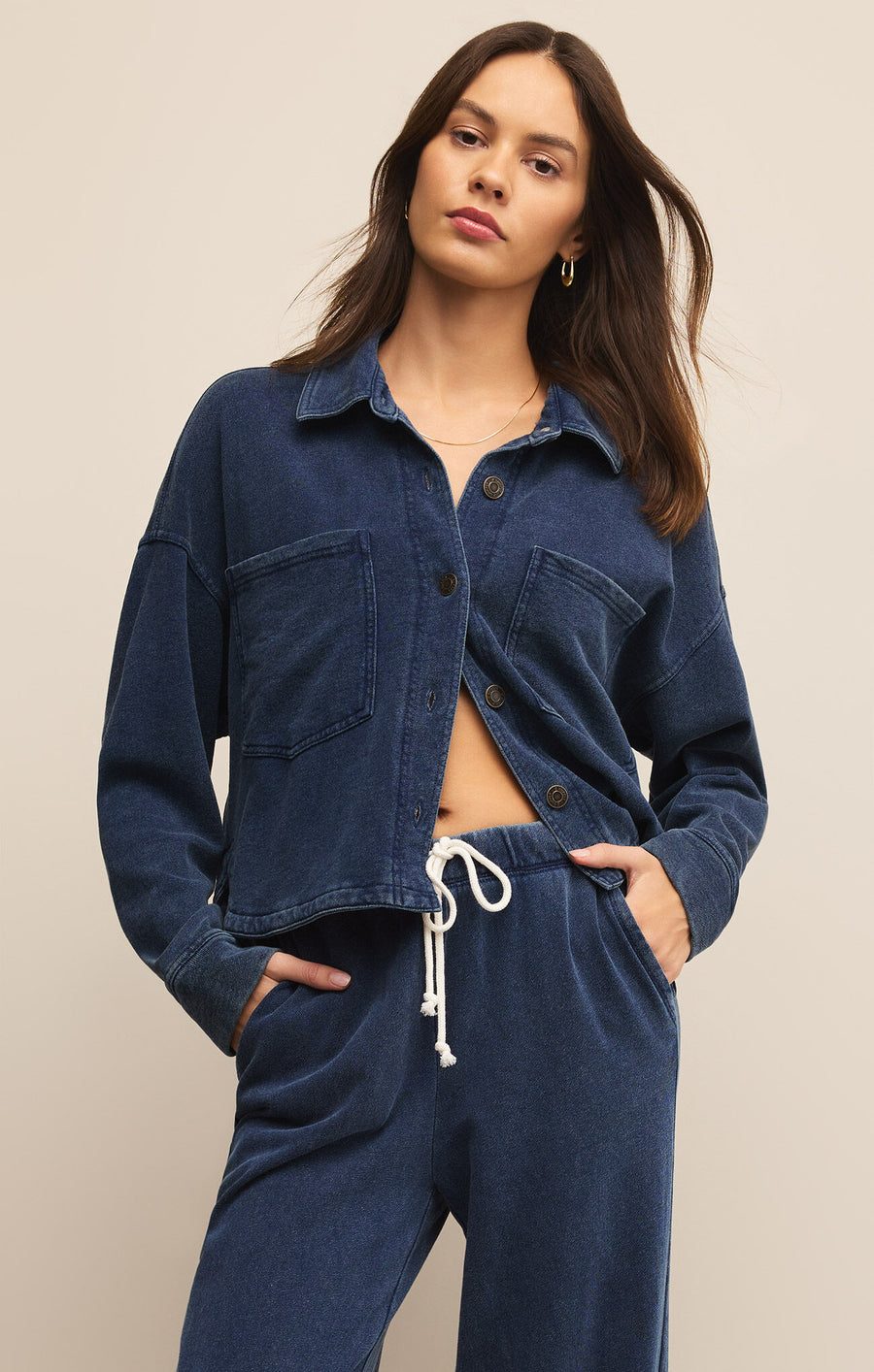 Featuring a relaxed fit long sleeve button up knit denim jacket in the color indigo 