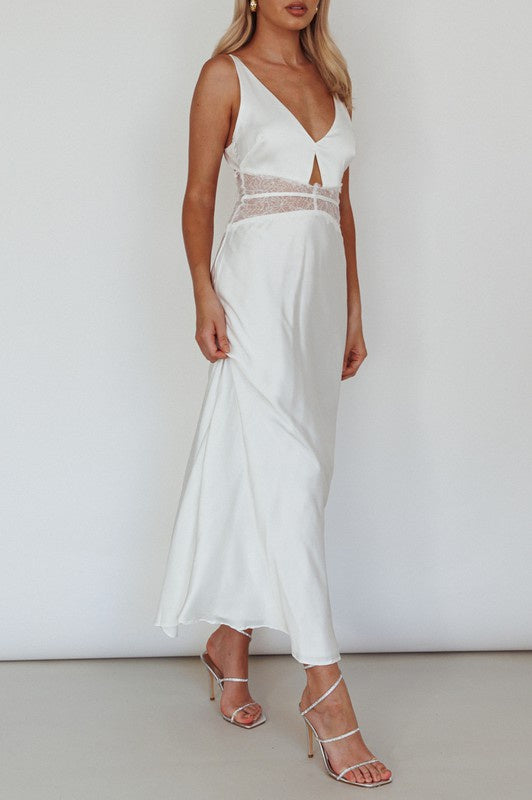 Featuring a V-neck lace cut out satin maxi dress with tie up back in the color white 