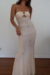 Featuring a fitted floor length strapless maxi dress with open front detail inthe color cream 