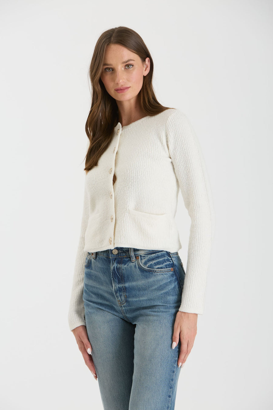 Featuring a long sleeve button up knit sweater in the color ivory 