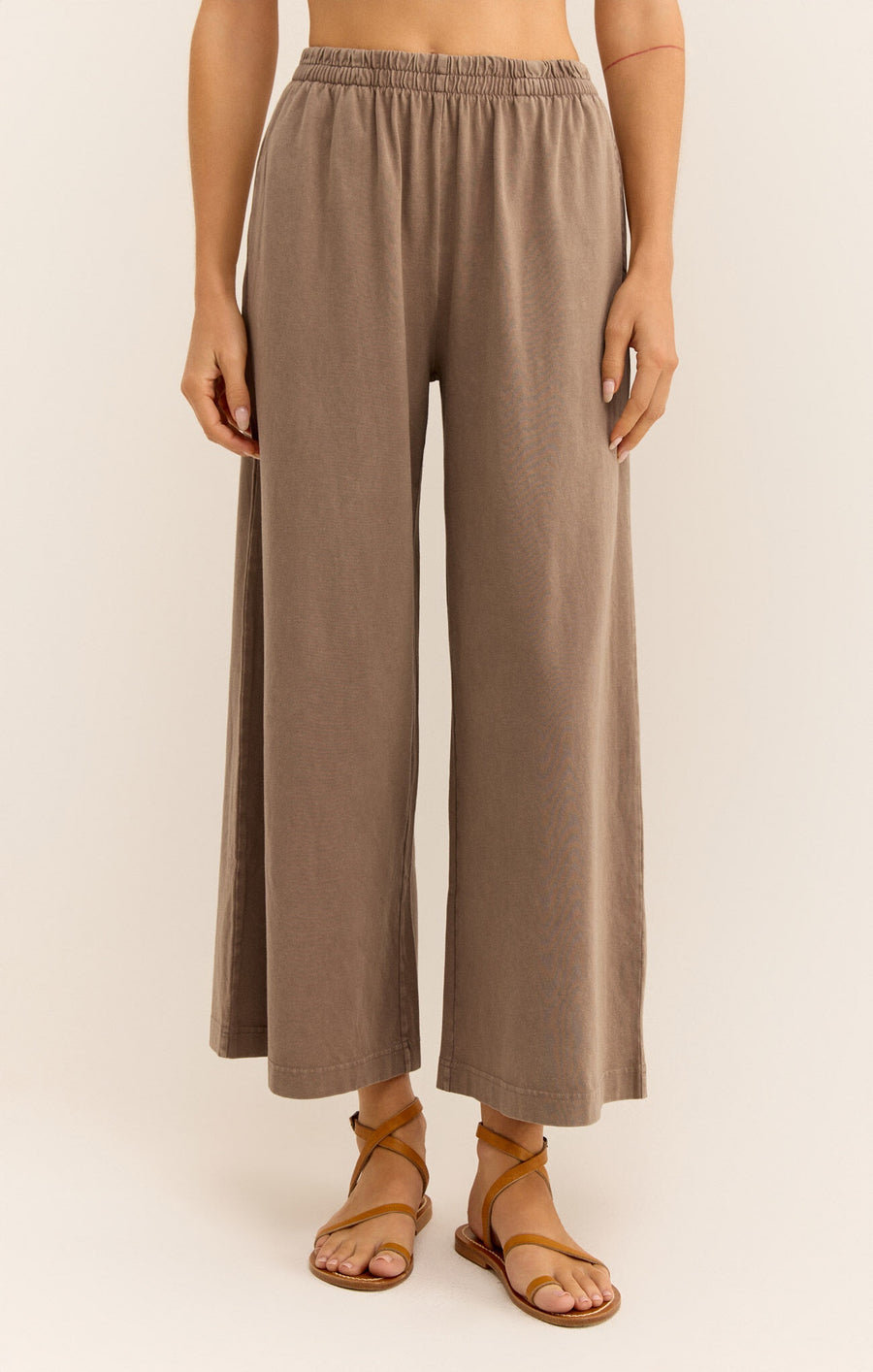 Featuring an elastic high waisted crop pant in the color iced coffee
