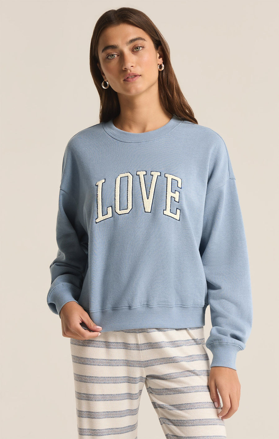 Featuring a crew neck long sleeve sweatshirt with the logo "Love"