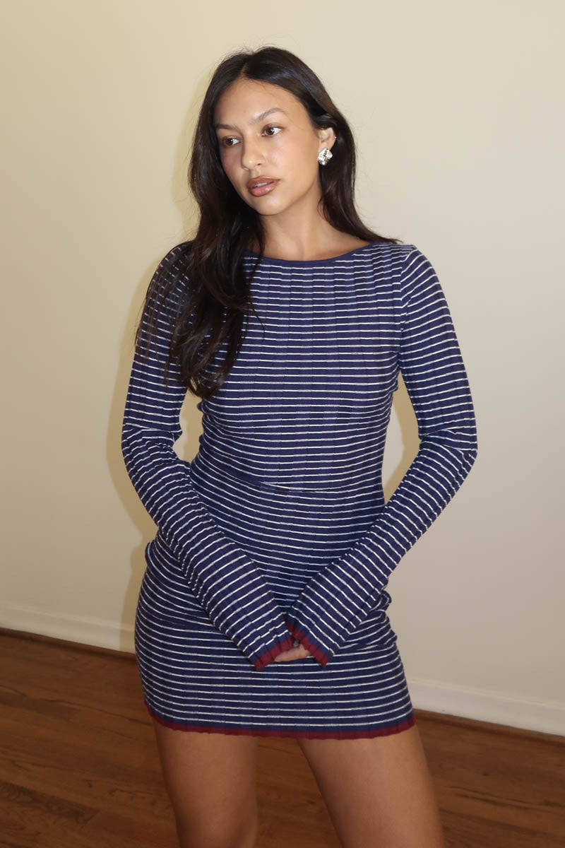 Featuring a long sleeve striped knit mini dress in the color midnight