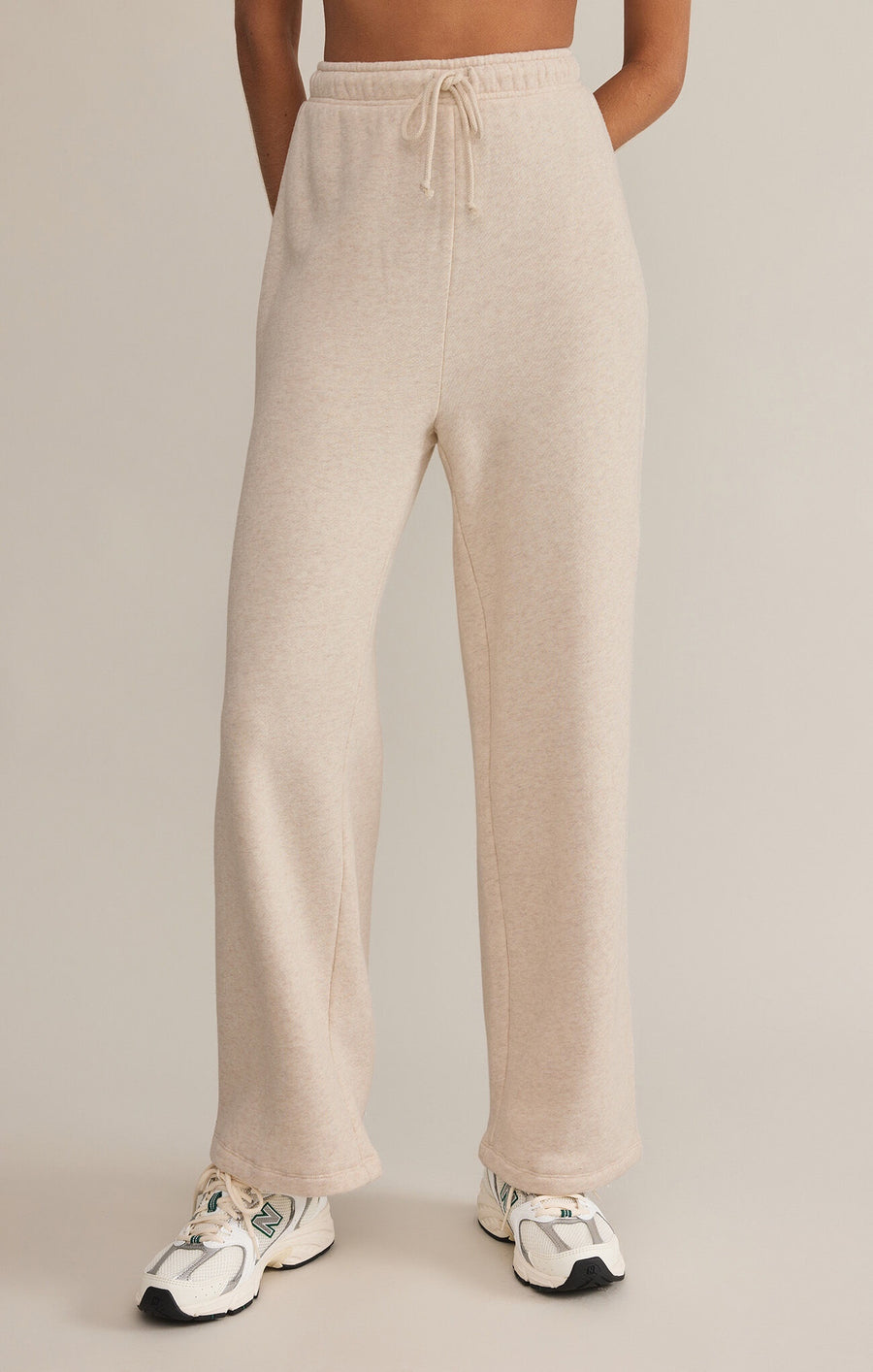 Featuring a relaxed fit draw string cozy sweatpant in the color oatmeal heather 