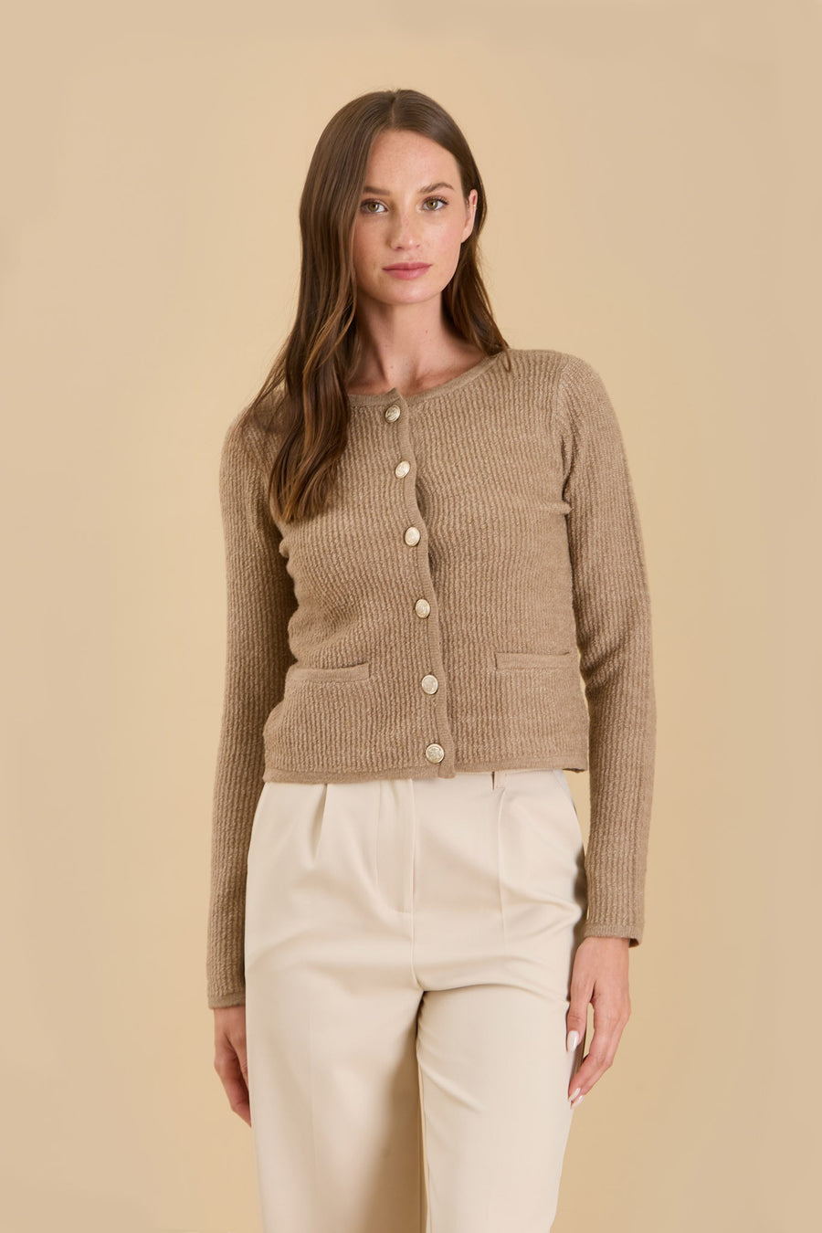 Featuring a long sleeve button up knit sweater in the color taupe 