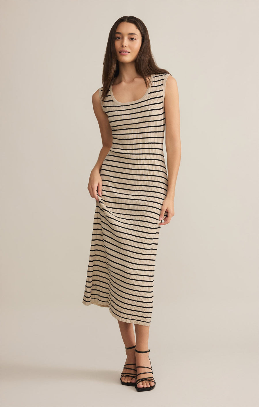 Featuring a sleeveless striped midi dress with a scoop neck in the color beige with black stripes