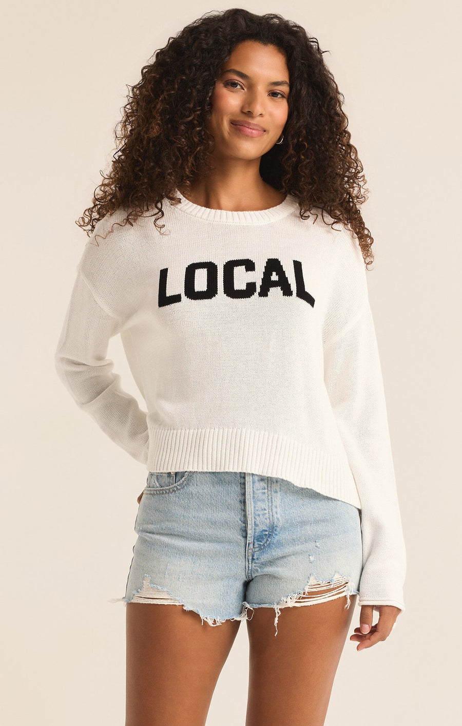 Featuring a longsleeve knit sweater with the logo "Locals" ikn the color white 