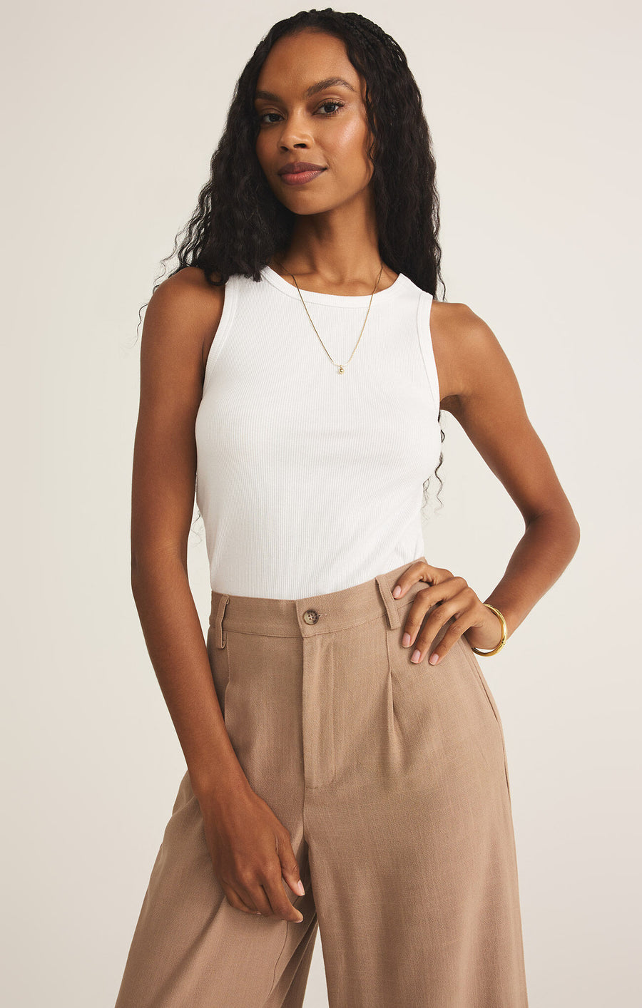 Featuring a ribbed fitted tank top in the color white 