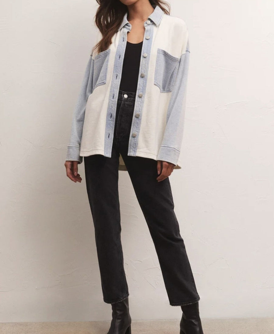 Soft denim jacket with color block pattern and a curved hem.