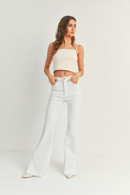 High rise boot cut jeans in the color white.