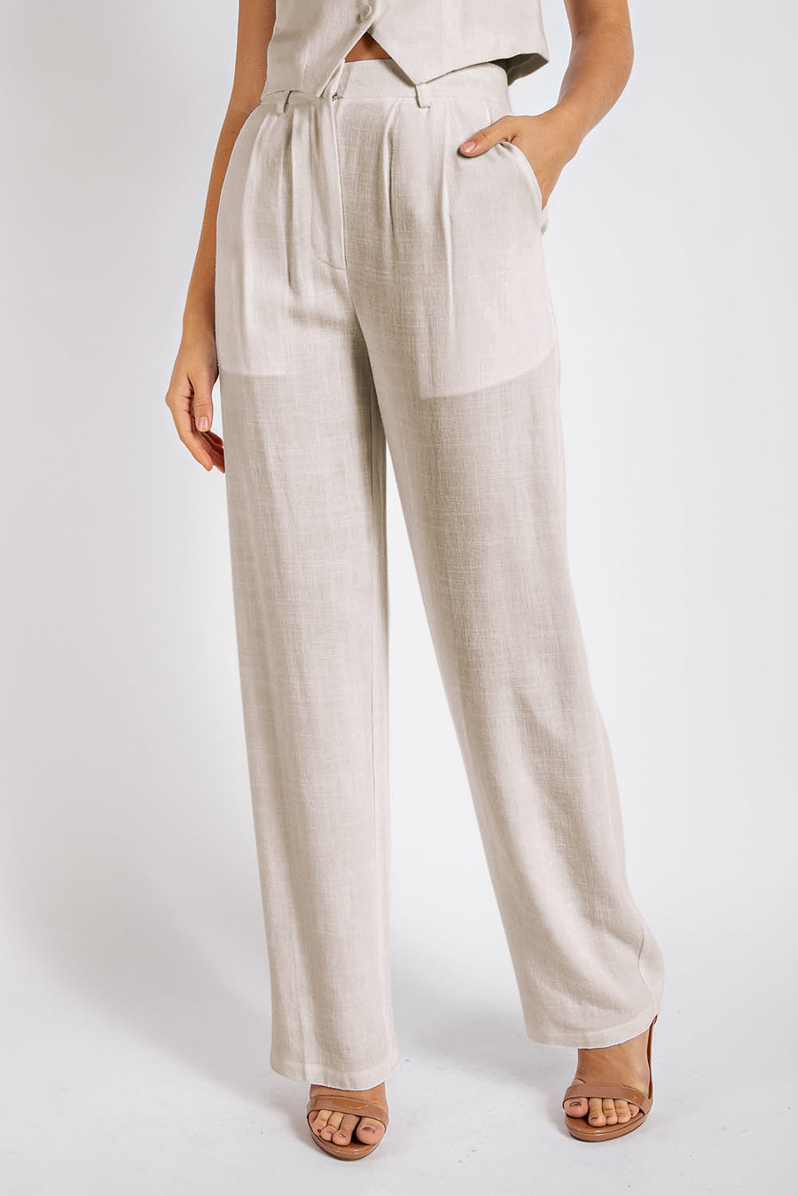 Beige business-casual style pant with two side pockets, belt loops, and a button with zipper on front. 