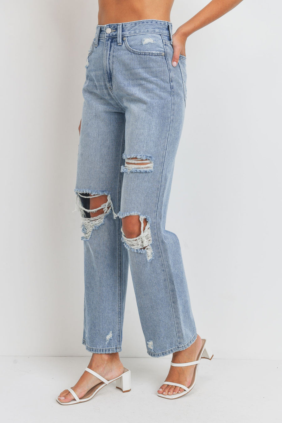 Loose fit jeans, high waisted, light denim with rips across the knees.
