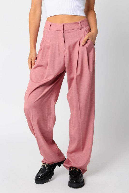 Model is wearing pink trousers