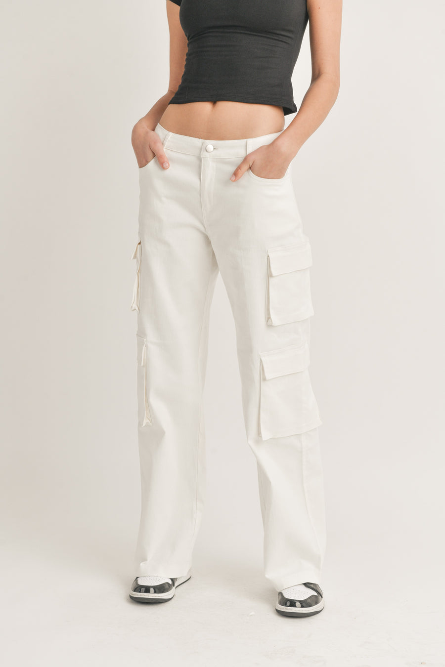 Featuring a straight leg cargo pant with two side pockets on each leg in the color off whte 
