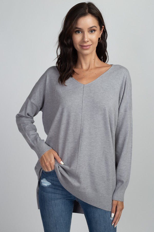Long sleeve thin sweater with middle seam in the color heather grey.