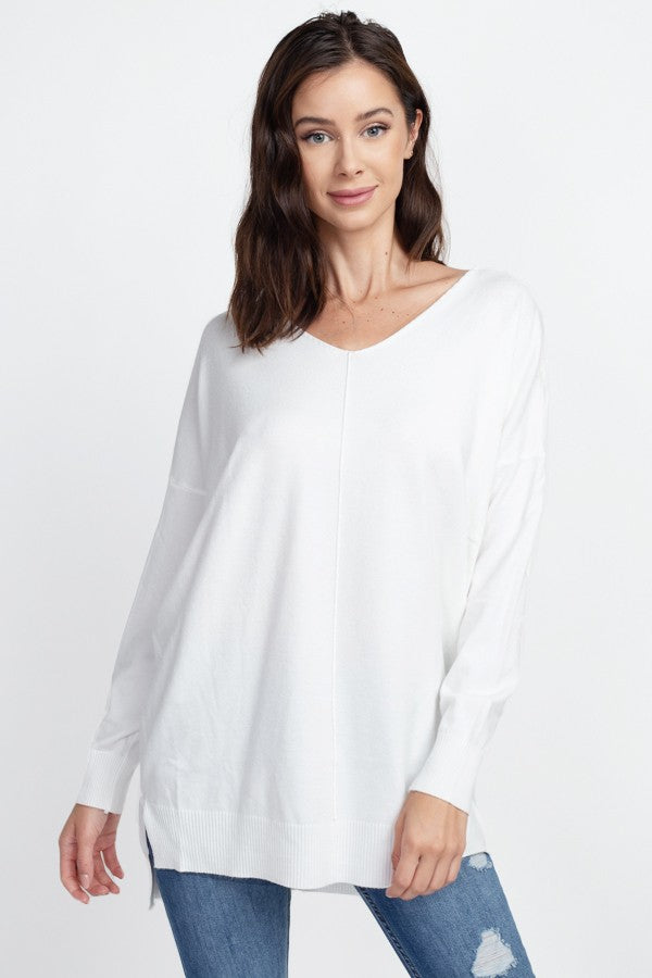 long sleeve thin sweater in the color white.