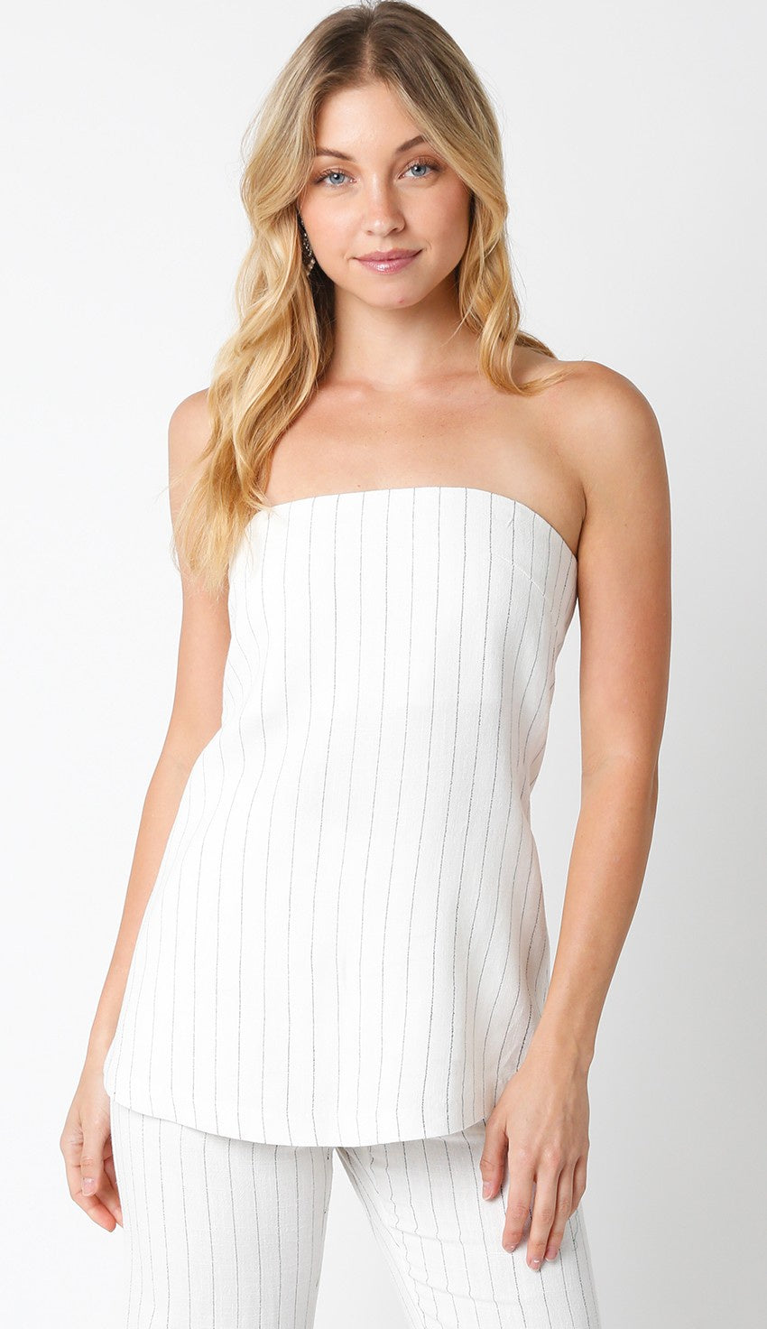 Featuring a strapless striped top with a zip up back in the color ivory and black