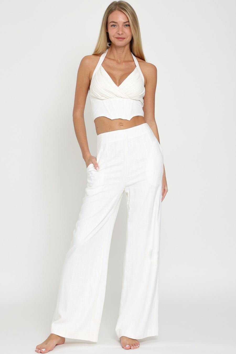 Pairs with the matching Zari Top Featuring a Mid rise loose fit pant with a back zipper detail in the color off white 