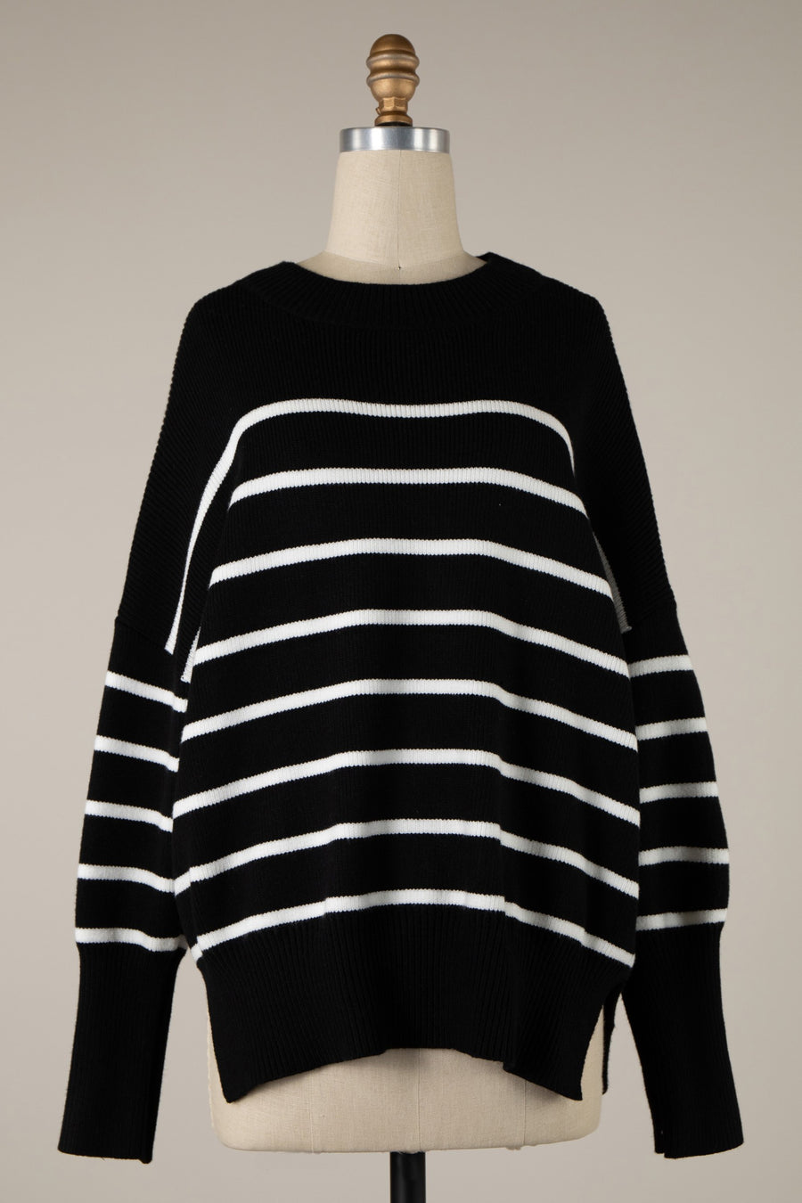 Featuring an over sized stripped black and white crew neck sweater