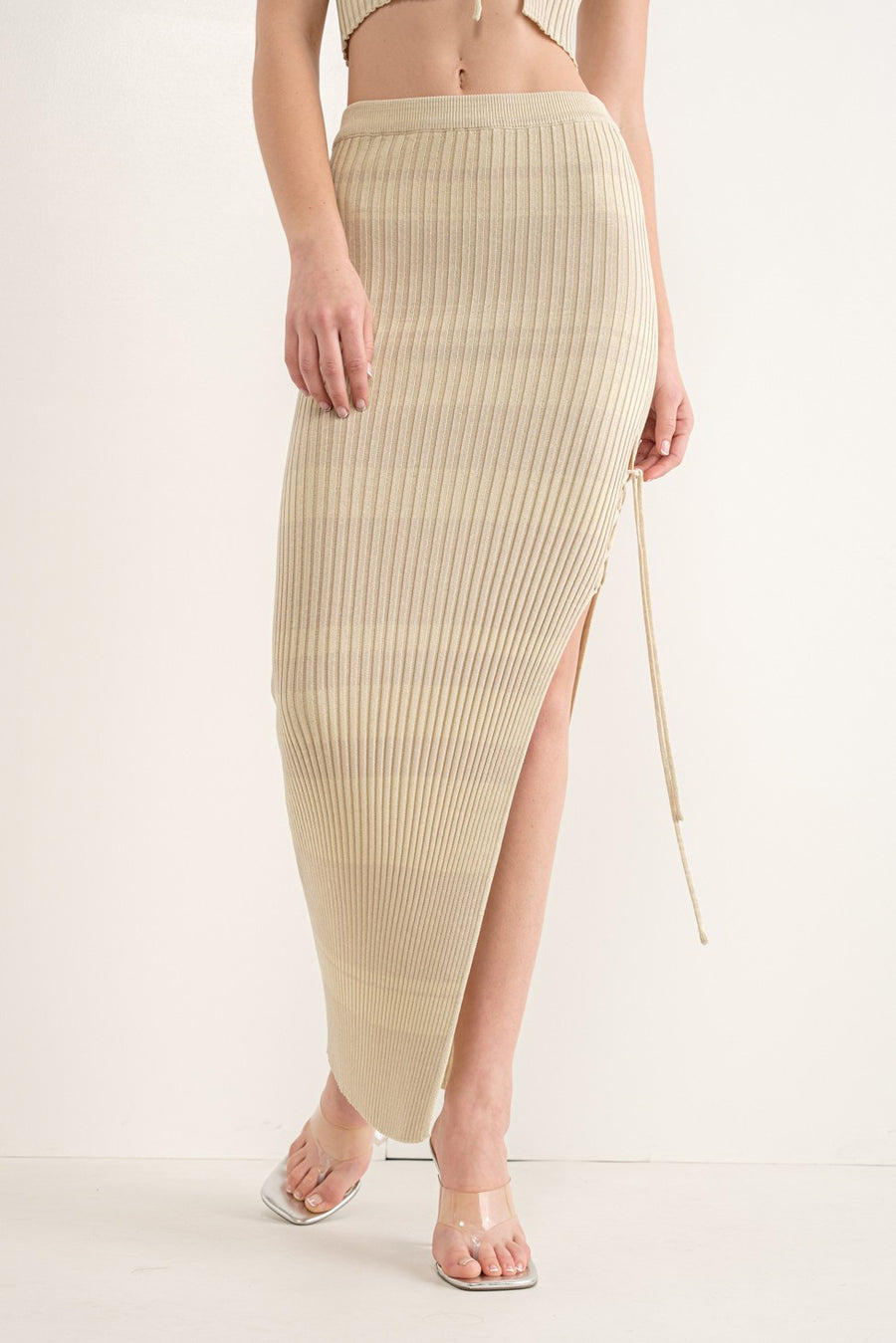 Two tone ribbed maxi skirt with elastic waist and slit with lace up detail in color ash. 