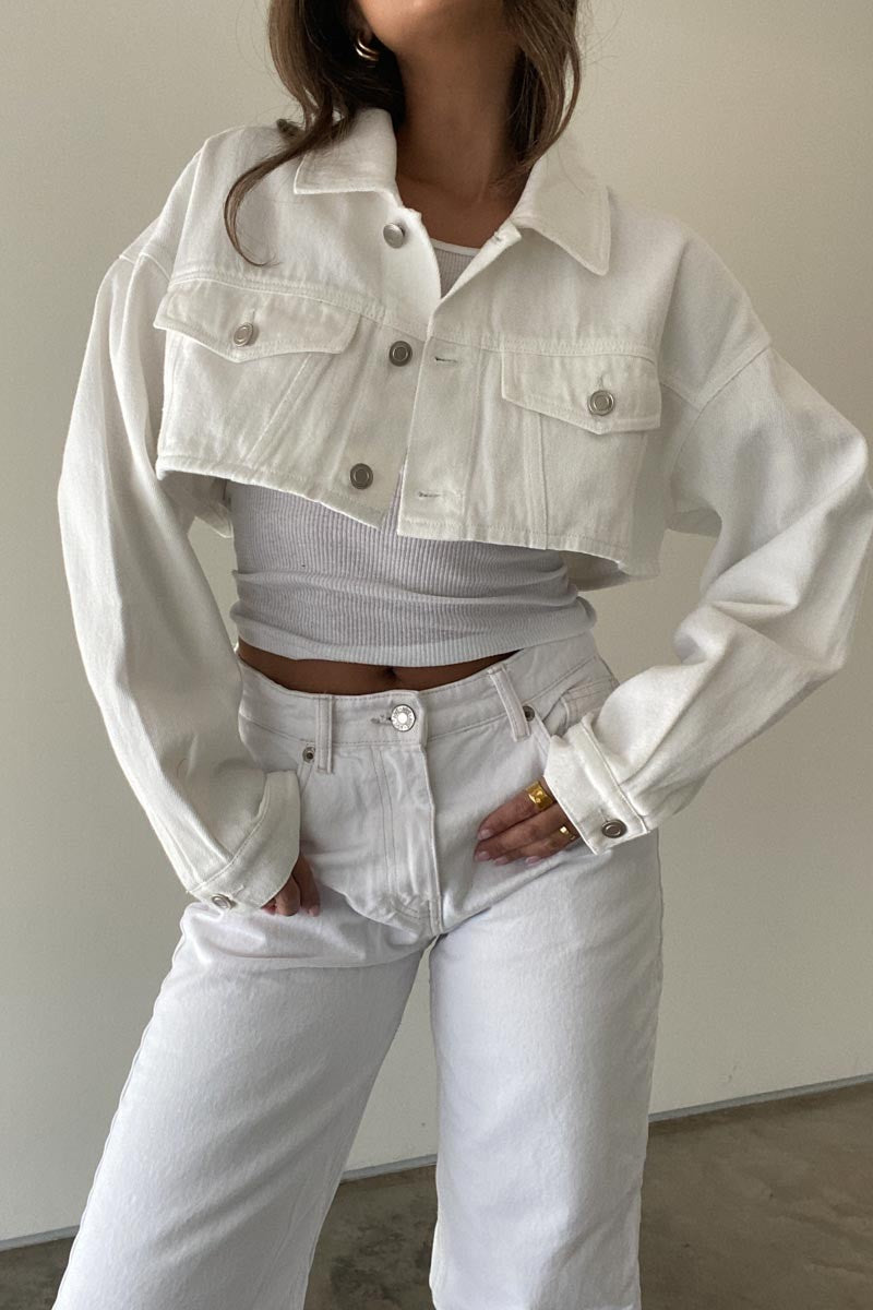 Featuring a cropped denim jacket in the color white 