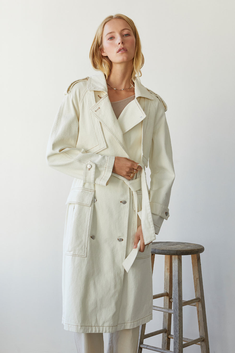 Trench Coat with front denim button closure, shoulder and sleeve flaps, and removable belt