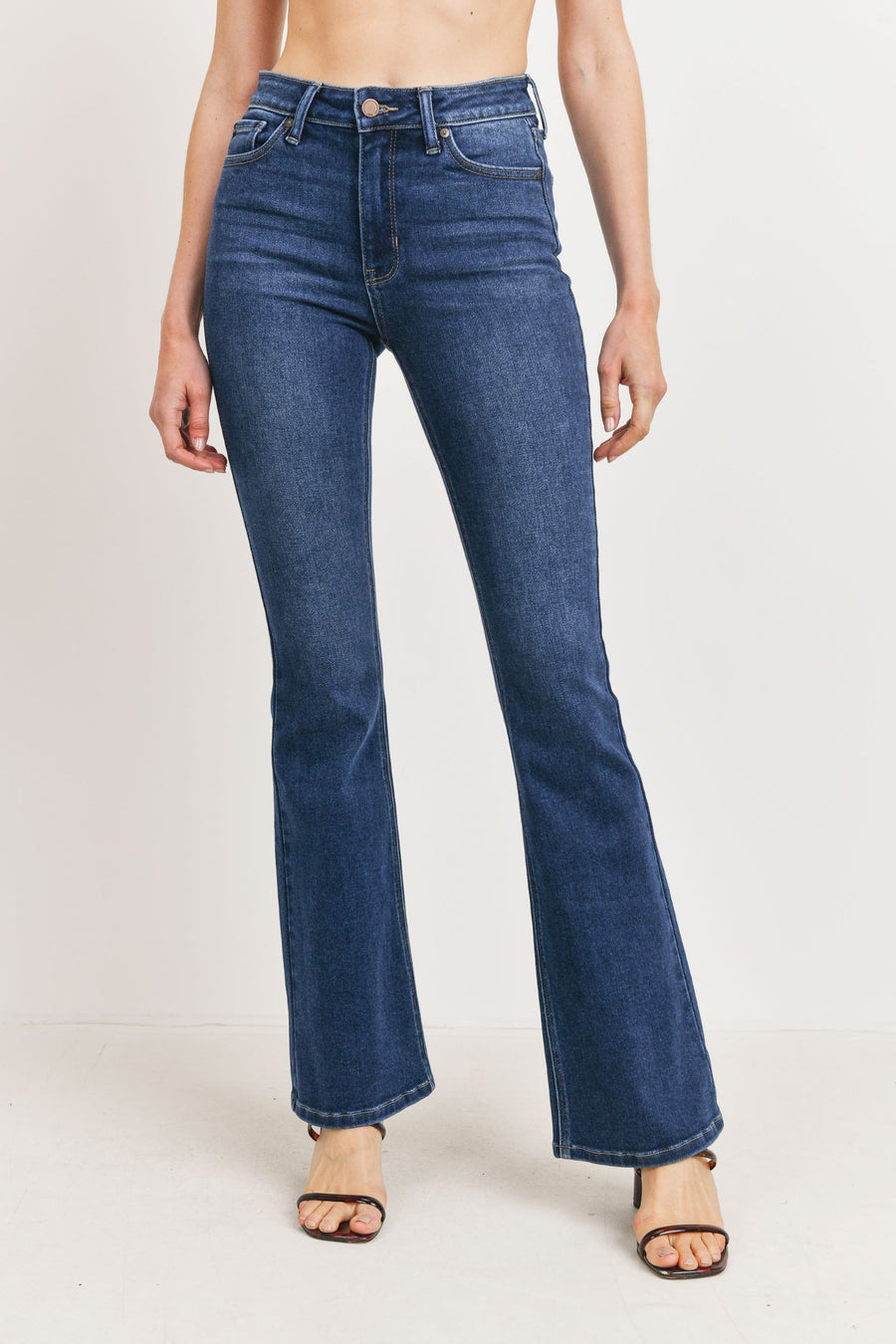 Long denim flare jeans with a button and zipper for closure in the front.