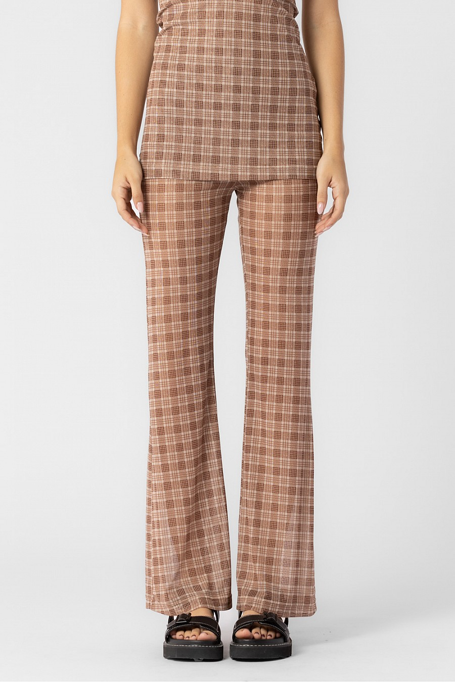 Checkered print pants in the color beige/brown.
