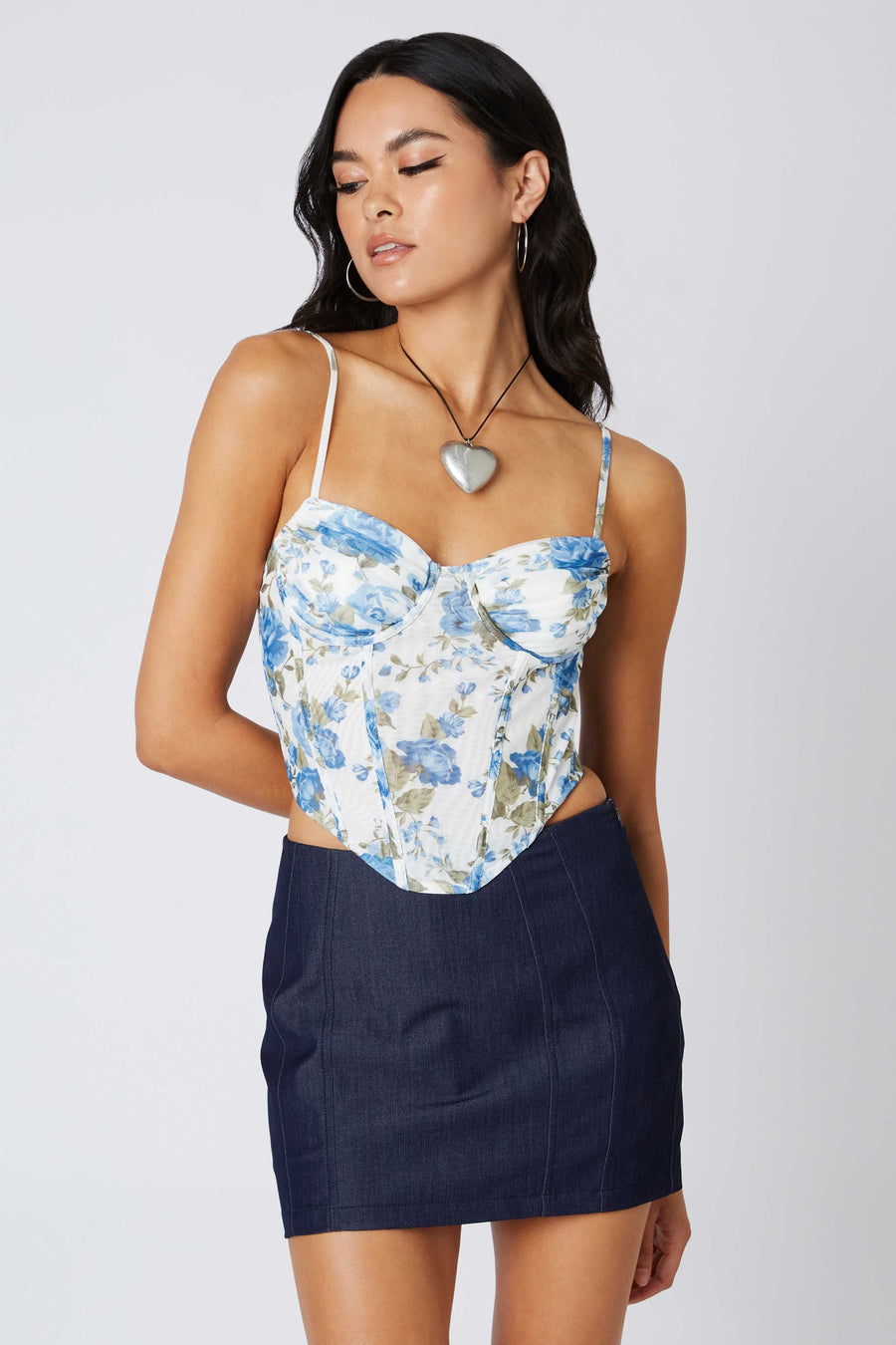 Corset style top with mesh fabric and floral pattern.